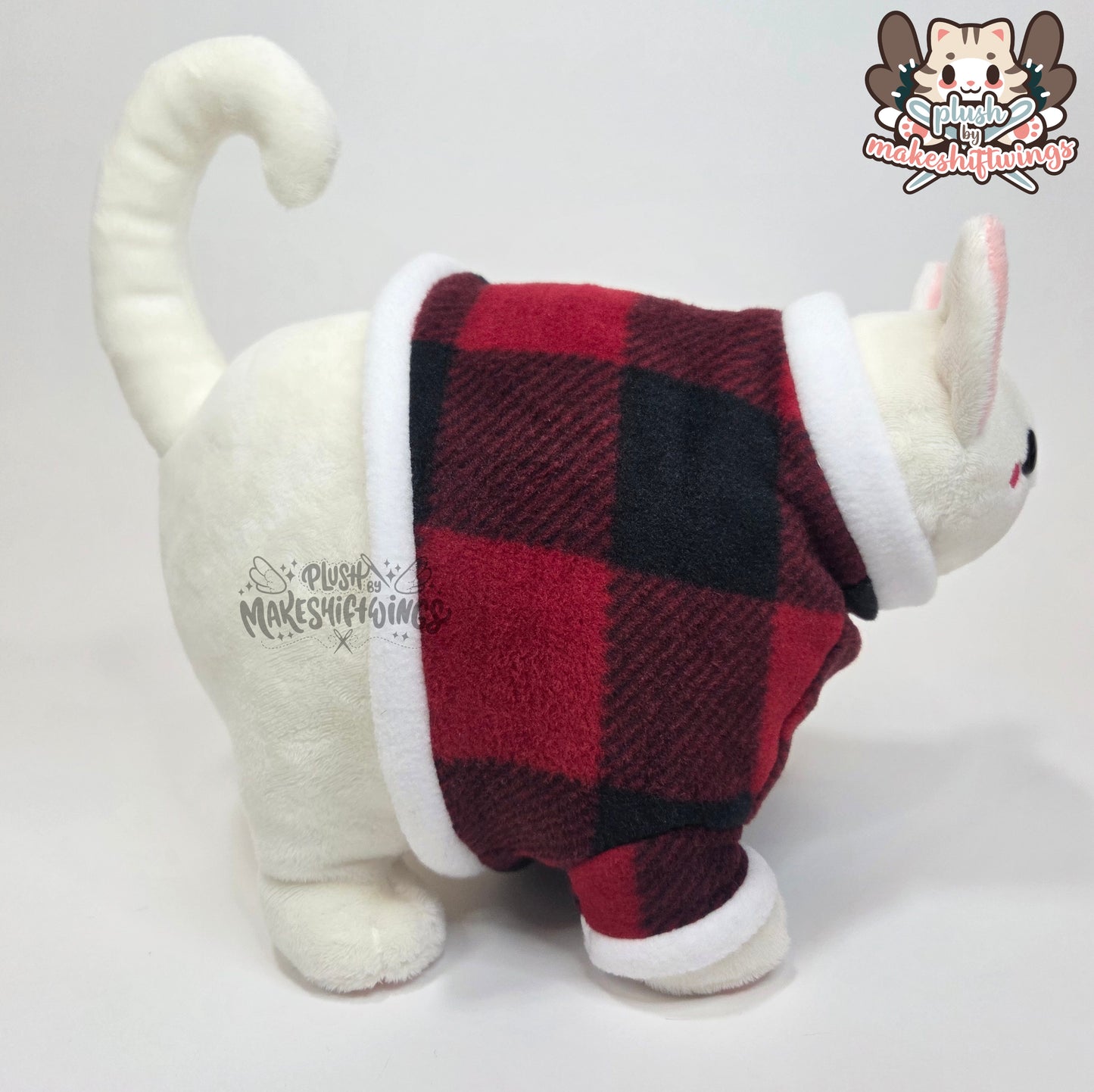 White fat cat in a sweater