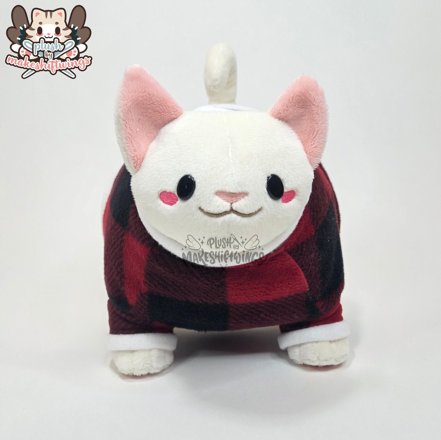 White fat cat in a sweater
